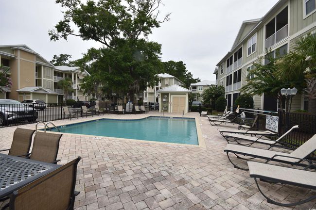 Community pool with a patio area and a residential view | Image 6