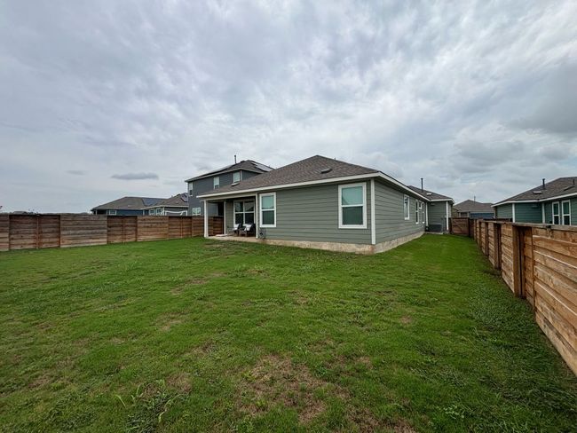Rear view of property featuring a fenced backyard | Image 5