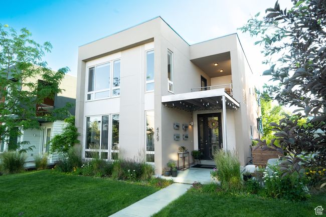Contemporary house featuring stucco siding, a balcony, and a front yard | Image 63