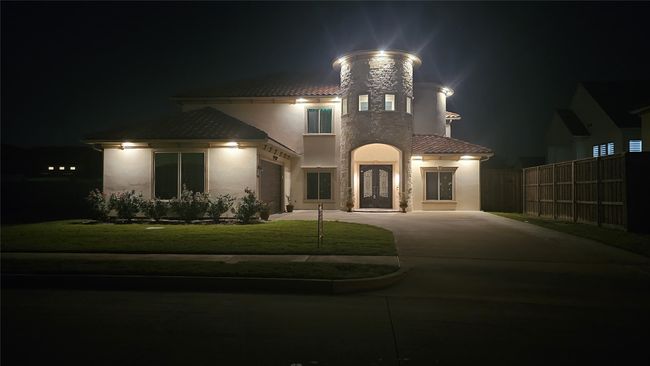 Mediterranean / spanish-style house with concrete driveway, a tile roof, and stucco siding | Image 39