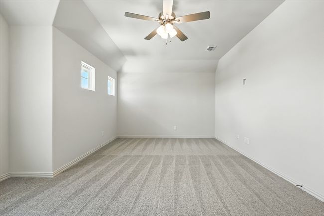 Carpeted empty room featuring a ceiling fan and baseboards | Image 28