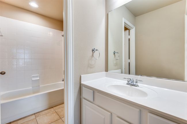 Jack & Jill bathroom featuring vanity, tile patterned flooring, shower combination, and recessed lighting | Image 16