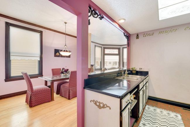 The wall between the kitchen and dining area has been opened up to bring the spaces together. | Image 13