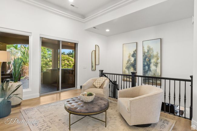 Living area with wood finished floors, an upstairs landing, recessed lighting, and ornamental molding | Image 37