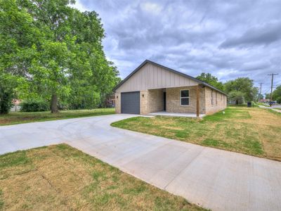 View of front of home featuring a garage and a front yard | Image 3