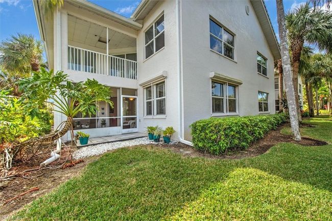 View of side of property with a balcony, a sunroom, stucco siding, and a lawn | Image 29