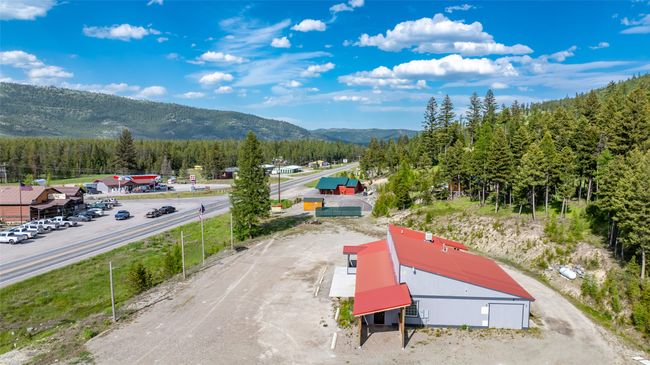 Drone / aerial view of a mountain backdrop and a forest | Image 97