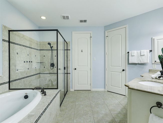 Full bathroom with a shower stall, a garden tub, double vanity, tile patterned floors, and recessed lighting | Image 21