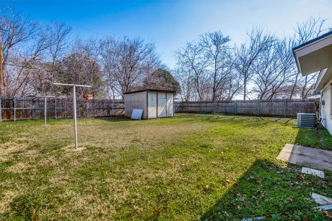 View of yard with a storage shed and central air condition unit | Image 24