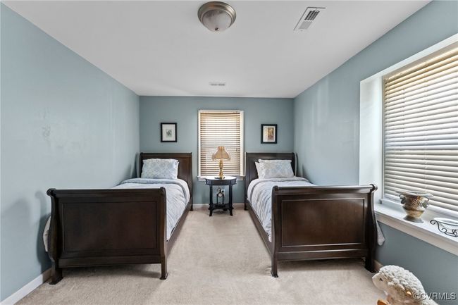 Bedroom featuring baseboards, visible vents, and light carpet | Image 35