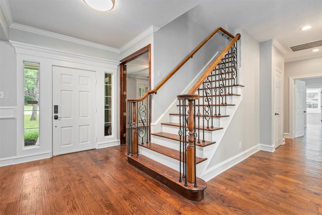 Foyer entrance with wood finished floors, crown molding, stairway, baseboards, and recessed lighting | Image 13