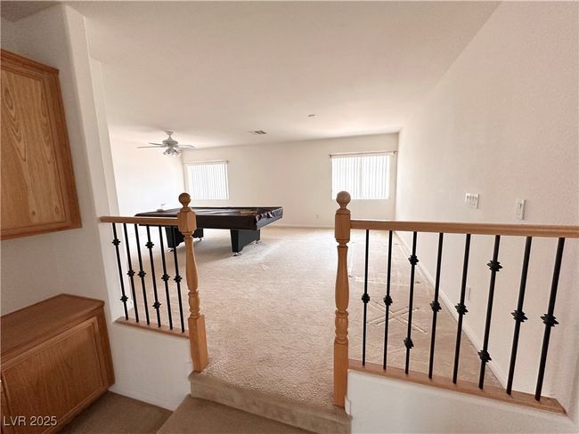Recreation room with carpet floors, billiards, and a ceiling fan | Image 18