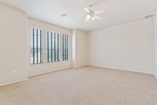 Spare room featuring carpet flooring, a ceiling fan, and visible vents | Image 20