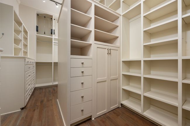 Spacious closet featuring dark wood-style floors | Image 15