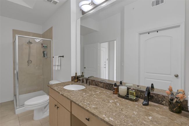 Full bathroom with a shower stall, vanity, and light tile patterned flooring | Image 17