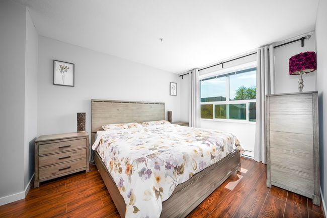 Bedroom featuring a baseboard radiator and dark wood finished floors | Image 14