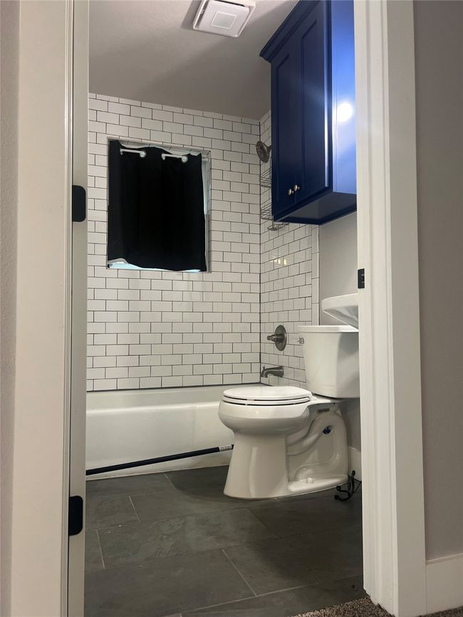 Full bathroom featuring washtub / shower combination and tile patterned flooring | Image 12