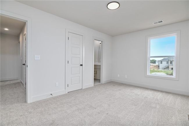 Unfurnished bedroom featuring light carpet and ensuite bath | Image 43