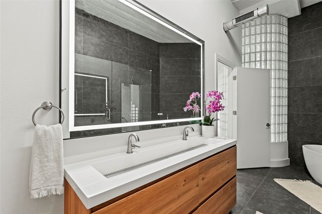 Bathroom featuring a soaking tub, a shower stall, tile patterned flooring, and vanity | Image 29