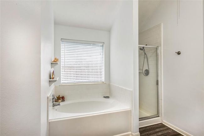 Primary bath features large soaking tub and seperate shower. | Image 24