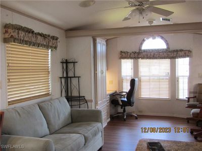 Living room featuring ceiling fan, ornamental molding, and hardwood / wood-style floors | Image 3