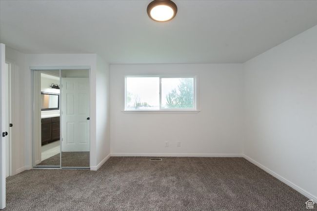 Unfurnished bedroom with baseboards, visible vents, and carpet | Image 20