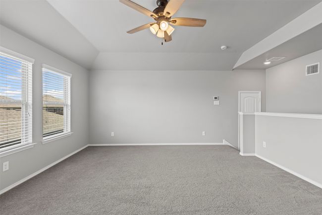 Unfurnished room with ceiling fan, carpet floors, lofted ceiling, and a smoke detector located upstairs | Image 19