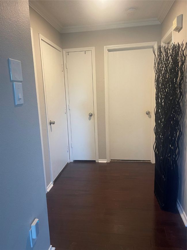 Hallway featuring dark wood-style flooring and crown molding | Image 20