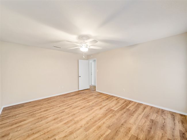 Spare room with ceiling fan, light wood finished floors, and baseboards | Image 13