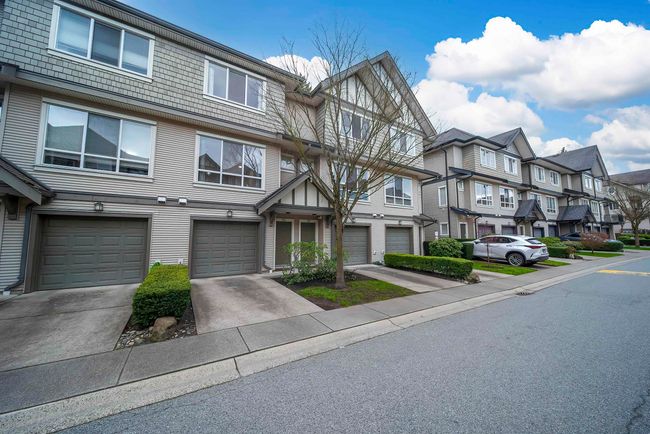 View of front of home with a garage, a residential view, and driveway | Image 31