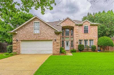 Front facade featuring a garage and a front yard | Image 1