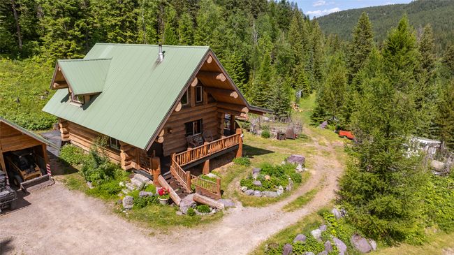 Aerial view of property and surrounding area with a heavily wooded area | Image 73