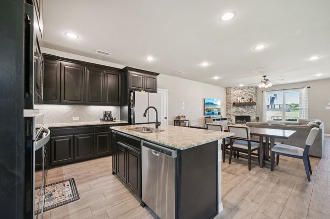 Kitchen with stainless appliances and open floor plan | Image 7
