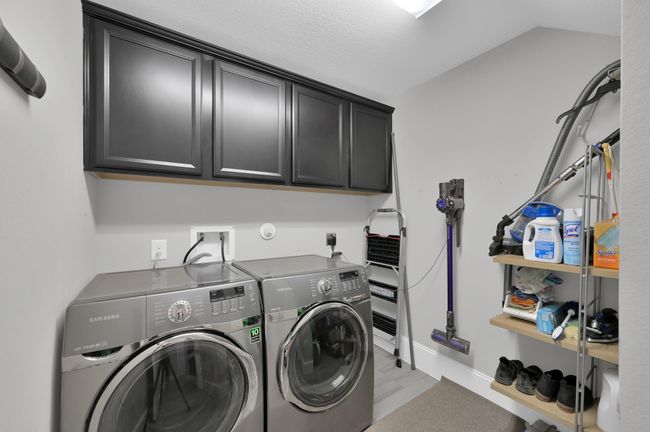 Laundry room conveniently tucked away off garage entry w/ Bonus storage under stairs | Image 23