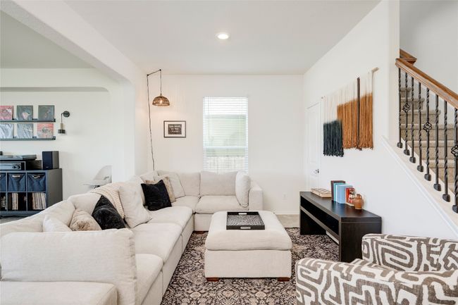 Carpeted living area with stairs, recessed lighting, and arched walkways | Image 4