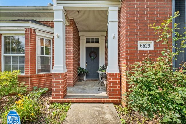 Welcoming front porch entry surrounded by nature | Image 14
