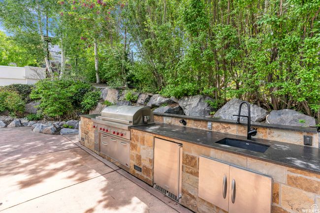 View of patio featuring a sink, exterior kitchen, and area for grilling | Image 100
