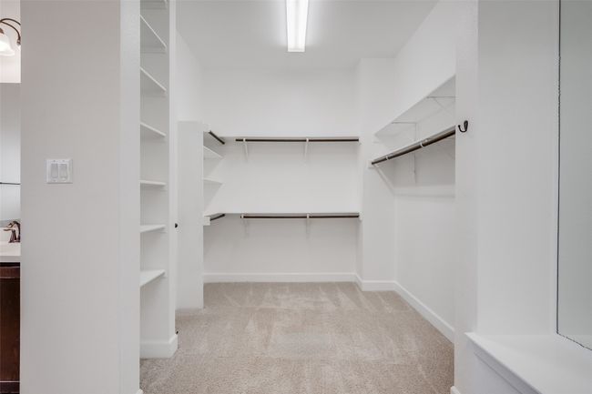Spacious closet featuring carpet floors and a sink | Image 21
