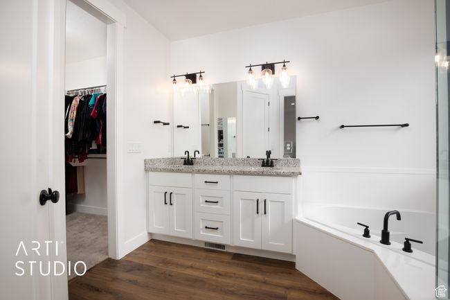 Bathroom with vanity, hardwood / wood-style floors, and a tub | Image 22