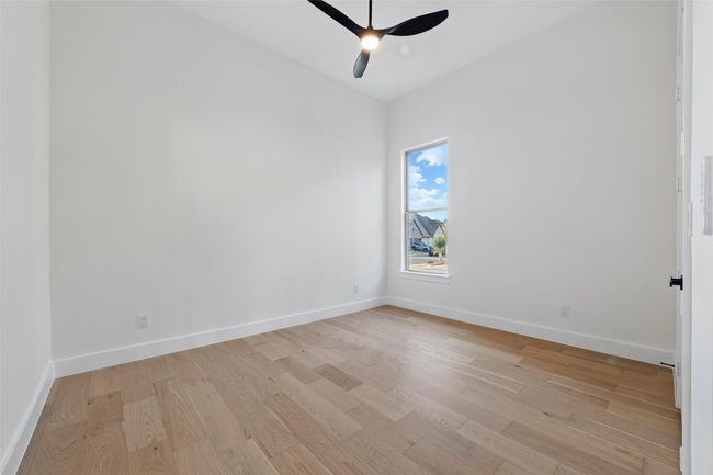 Spare room featuring baseboards, light wood finished floors, and ceiling fan | Image 19