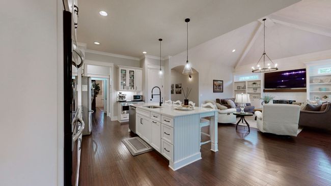The heart of the home! This open-concept kitchen and living space features vaulted ceilings, custom lighting, and built-ins—perfect for everyday living and entertaining with ease. | Image 19