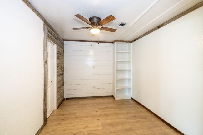 Unfurnished room with visible vents, light wood-style flooring, and ceiling fan | Image 16