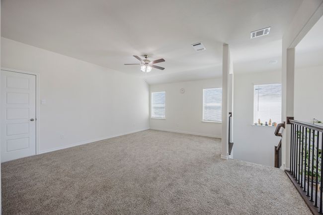 Carpeted empty room featuring ceiling fan and healthy amount of natural light | Image 17