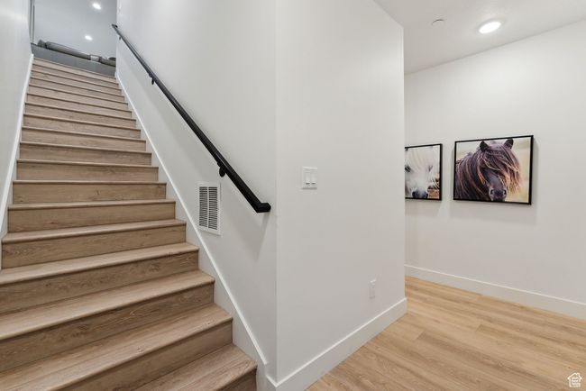 Stairway featuring hardwood / wood-style flooring | Image 33