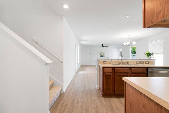The open layout smoothly combines the living room, kitchen, and dining area into one harmonious and inviting space. | Image 26