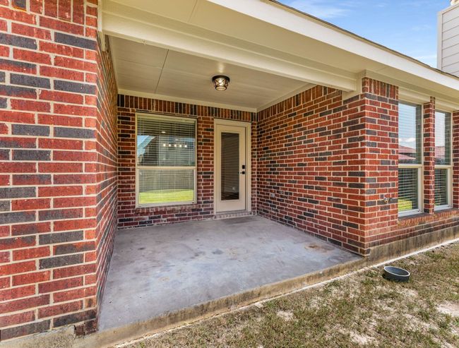 Property entrance with brick siding, a patio area, and a chimney | Image 36