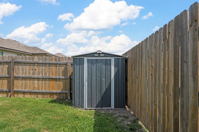 View of shed with a fenced backyard | Image 33
