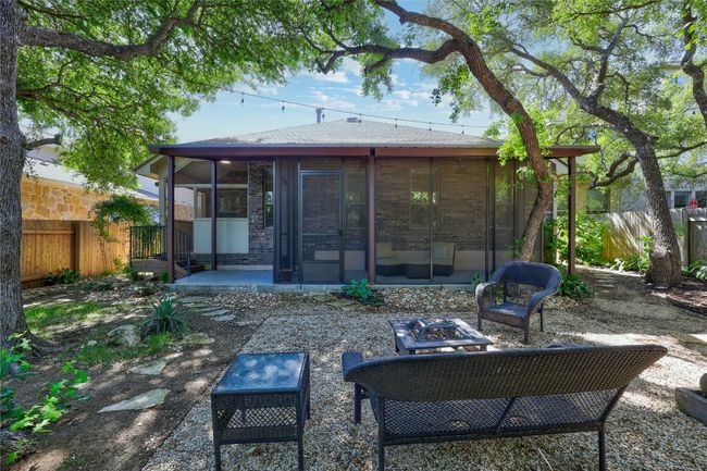 Back of house featuring a screened patio area, an outdoor fire pit | Image 35