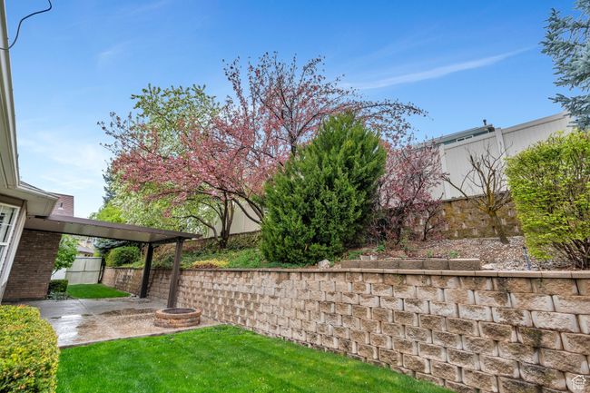 View of yard featuring a patio area, a fenced backyard, and a fire pit | Image 34