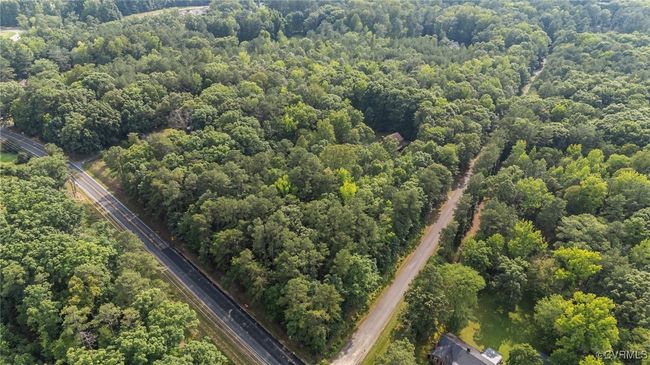 Aerial view of property and surrounding area featuring a heavily wooded area | Image 39